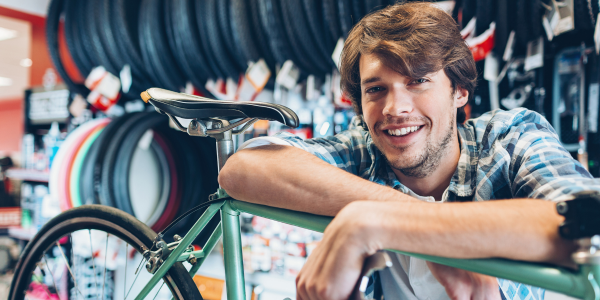 Business owner leaning on bike